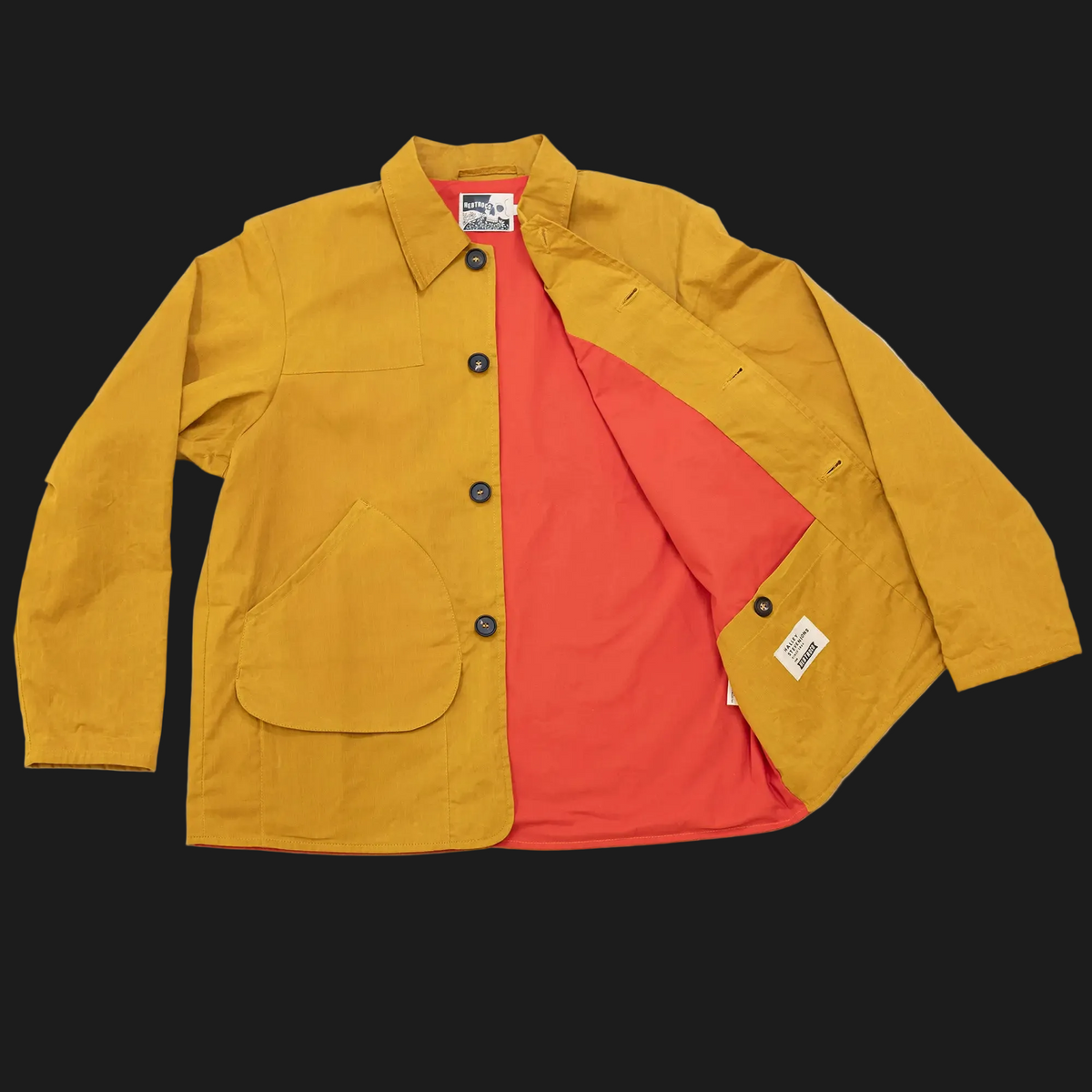A mustard yellow jacksnipe jacket with a bright red-orange interior lining, shown open on a plain white background.