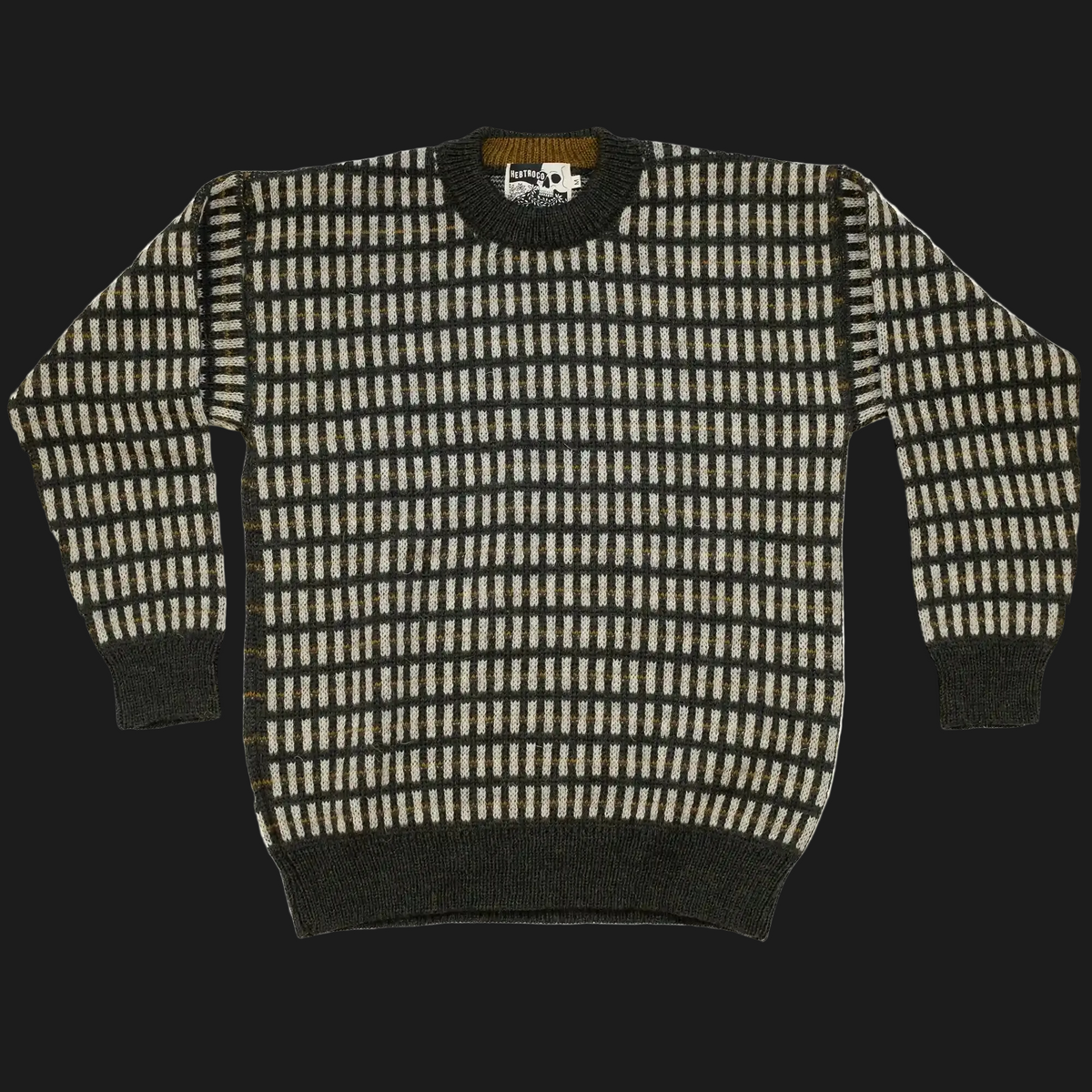 A long-sleeve knit sweater with a green and cream geometric checkered pattern, featuring solid dark green ribbed cuffs, collar, and hem, laid flat against a dark background.