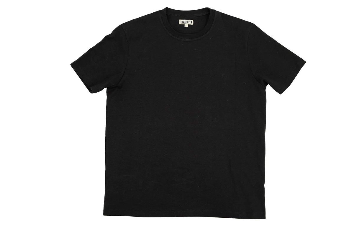 A black short-sleeve crewneck t-shirt laid flat against a solid white background, with a small white brand label visible inside the collar.