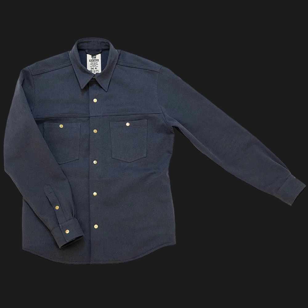 A  navy bedford cord ironshirt with two chest pockets and brass buttons, laid flat on a white background.