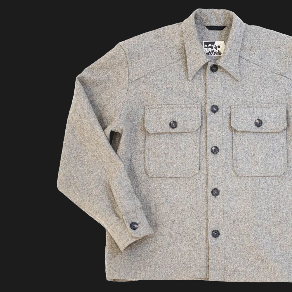 A USB37 wool overshirt  with a button-down front, two chest flap pockets, and a pointed collar, shown on a plain white background.